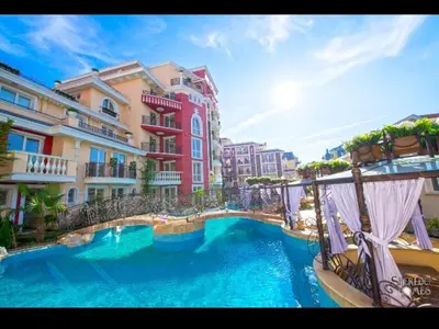 a large swimming pool in front of a building at Messembria Resort in Sunny Beach