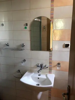 a bathroom with a sink and a mirror at Apartment Black Sea Shark in Chernomorets