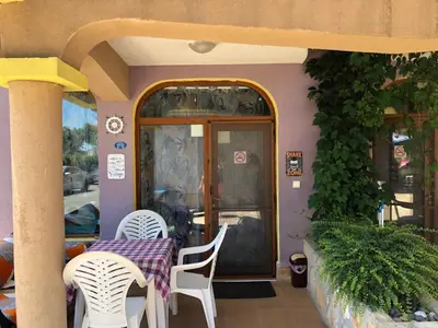 a table and chairs sitting outside of a restaurant at Apartment Black Sea Shark in Chernomorets