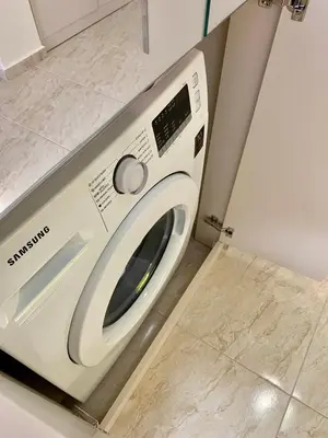 a white washing machine sitting in a kitchen at Beige-a-view, Sea Dreams in Sveti Vlas
