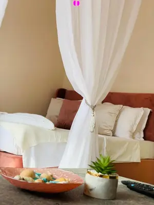 a bedroom with a bed and a bowl of fruit on a table at Beige-a-view, Sea Dreams in Sveti Vlas