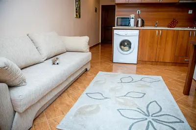 a living room with a couch and a washing machine at Helios Studio in a Complex in St Vlas by Flat Mаnаger in Sveti Vlas