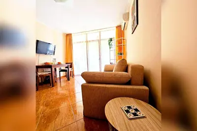 a living room with a couch and a table at Helios Studio in a Complex in St Vlas by Flat Mаnаger in Sveti Vlas