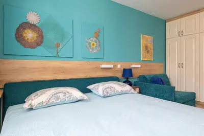 a bedroom with a bed with two pillows on it at Turquoise in Pomorie