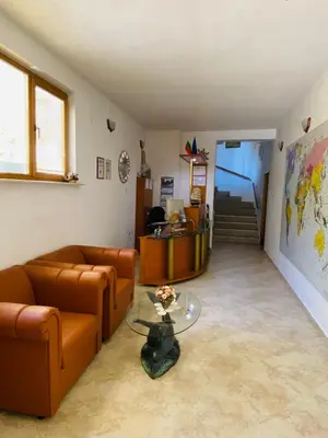 a living room with a couch and a glass table at Family Hotel The Golden fish in Sozopol