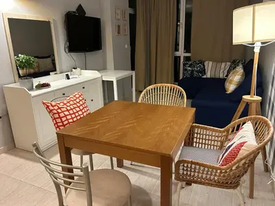 a living room with a wooden table and chairs at Pollo Resort, Summer Wind Apartaments in Sunny Beach
