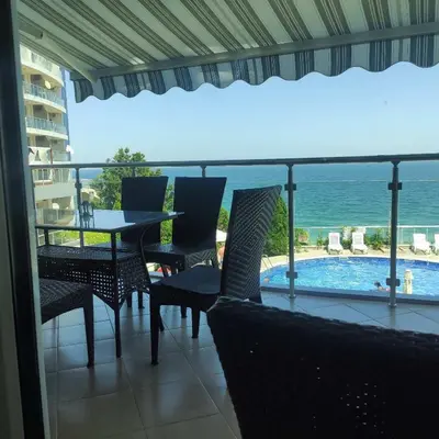 a balcony with a table and chairs and a view of the ocean at Silver A28 in Byala