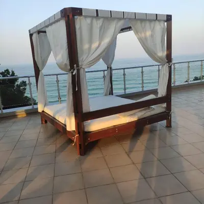 a bed on a balcony with the ocean in the background at Silver A28 in Byala