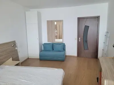 a room with a blue chair and a door at Silver A28 in Byala