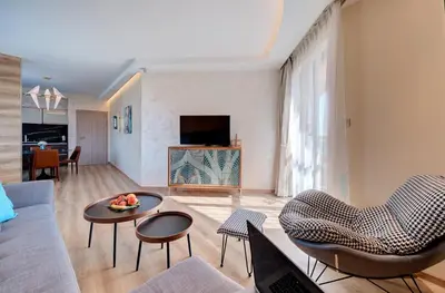 a living room with a couch and a table and chairs at Beachfront Smart Homes by Marty's in Sunny Beach