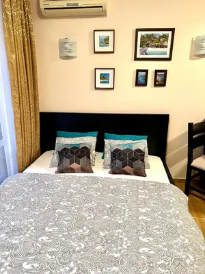 a bedroom with a bed and some pictures on the wall at Paradise Dreams apartment in Sveti Vlas