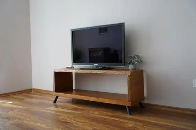 a flat screen tv sitting on top of a wooden stand at Atlantis Atmosphere Apartment in Burgas City