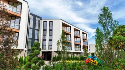 an apartment building with a garden in front of it at Atlantis Atmosphere Apartment in Burgas City