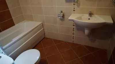 a bathroom with a sink and a toilet and a bath tub at Апартамент Сънрайз Обзор - Apartment Sunrise Obzor in Obzor