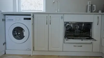 a kitchen with a washing machine and a washer at Апартаменти Атеа на плажа - Apartments Atea on the beach in Obzor