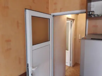 a door that is open in a room at Удобство in Burgas City