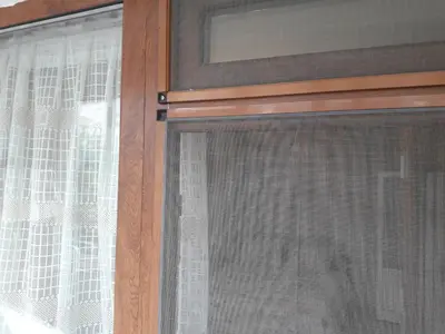a window with a curtain on it with at Удобство in Burgas City