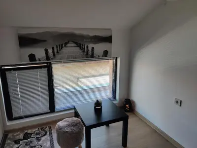 a room with a table and a large window at Apartment 7 in Tsarevo