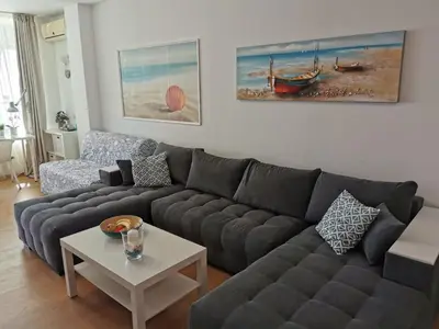 a living room with a couch and a table at Silver A 27 in Byala