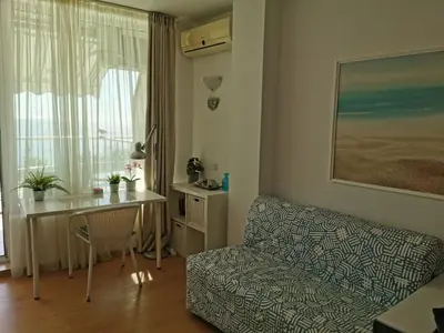 a living room with a couch and a table and a window at Silver A 27 in Byala