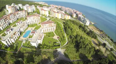 an aerial view of a resort on a hill next to the ocean at Fort Noks - Menada Apartments in Sveti Vlas