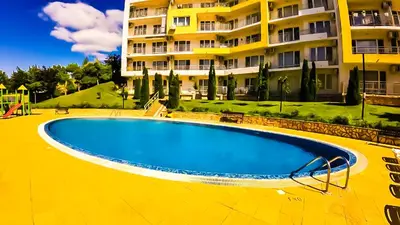 an empty swimming pool in front of a building at William's apartments - third special studio in Sveti Vlas