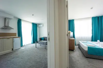 a hotel room with a bed and a kitchen at Hotel Zonya in Sunny Beach
