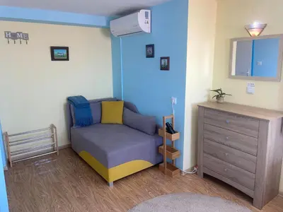 a small room with a couch and a dresser at Къща за гости ЕЛЕНИ in Sozopol
