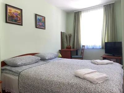 a bedroom with a bed with two towels on it at Къща за гости ЕЛЕНИ in Sozopol