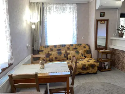 a living room with a couch and a table at Къща за гости ЕЛЕНИ in Sozopol