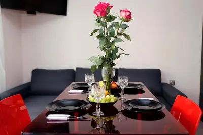 a table with a rose in a vase on it at Deluxe 2 Studios City Center in Burgas City