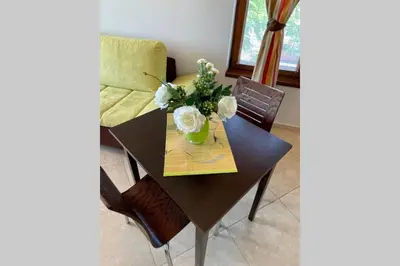 a dining room table with a vase of flowers on it at Apartment Doris in Sunny Beach