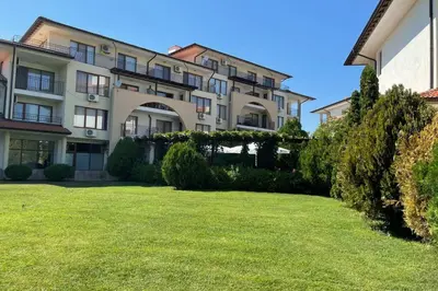 a large apartment building with a lawn in front of it at Apartment Doris in Sunny Beach
