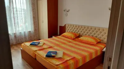 a bedroom with a large bed with two towels on it at Акротирия Фешева in Nesebar