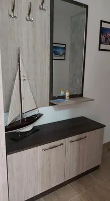 a model boat on a counter with a mirror at Акротирия Фешева in Nesebar