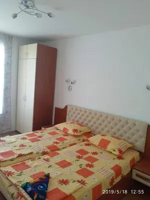 a bedroom with a bed with a quilt on it at Акротирия Фешева in Nesebar