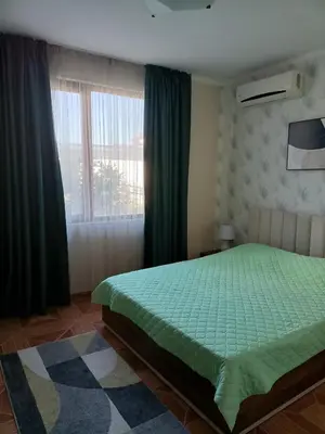 a bedroom with a green bed and a window at Sun Wave EXCLUSIVE in Sveti Vlas