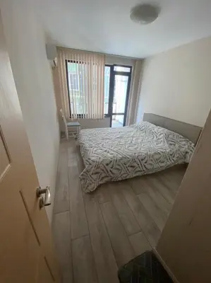 a bedroom with a bed and a wooden floor at VINTAGE Top Centre in Burgas City