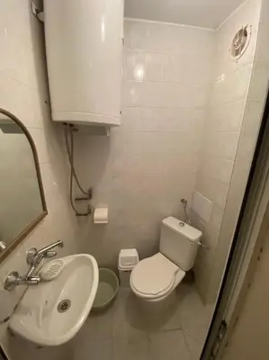 a small bathroom with a toilet and a sink at VINTAGE Top Centre in Burgas City