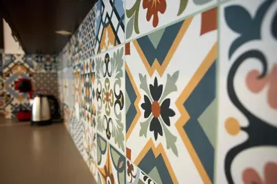 a room with a wall covered in colorful tiles at Luxury First Line apartment with pool by the sea in Nesebar