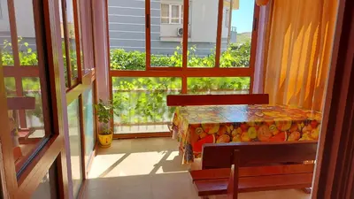 a dining room with a table and a window at Апартамент Златна дюна-Фешева in Nesebar