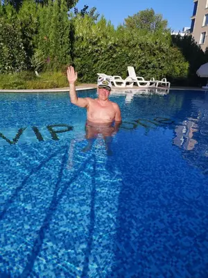 a man is swimming in a pool of water at Studio VIP-ZONE in Sunny Beach
