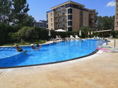a group of people sitting in a swimming pool at Studio VIP-ZONE in Sunny Beach