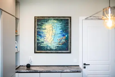 a painting hanging on a wall next to a door at Smart Central Apartment in Varna City