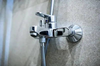 a shower head in a bathroom with a sink at Smart Central Apartment in Varna City