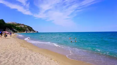 a group of people swimming in the ocean on a beach at Byala Vista Beach Apartments D - Бяла Виста Бийч Апартментс Д in Byala