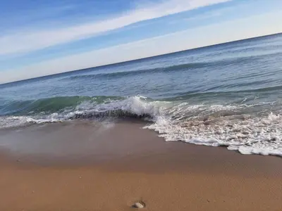 a wave breaking on a beach with the ocean at Byala Vista Beach Apartments D - Бяла Виста Бийч Апартментс Д in Byala