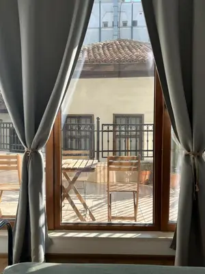 a window with a view of a balcony with a chair at Atelier 26 in Varna City