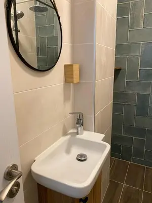 a bathroom with a sink and a mirror at Atelier 26 in Varna City