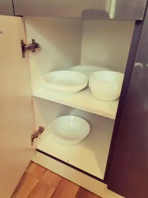 a bathroom with two white bowls and plates on shelves at Family Apartments Amadeus lux in Sunny Beach